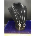 3 silver necklace s with pendants.