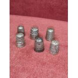 Collection of silver Hall marked thimbles etc.