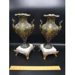 Pair of art nouveua style cast metal vases with marble base and ormalou feet. 12 inches in height .
