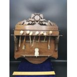 Large black forest carved pipe rack with bone inlays together with collection of pipes.