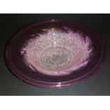 Scottish Monart glass bowl has a rim mainly found in this shape colours are pink and purple. Shape