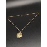 14kt gold chain with 14 kt pendant set with green stone.