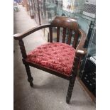 Antique oak captains arm chair with bobble supports.