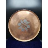 Arts and crafts copper platter with silver flower decoration.