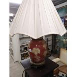 Large ornate table lamp with leaf design.