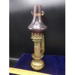 Antique brass railway oil lamp with glass shade.