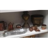 Shelf of brass wares to include brass oil lamp.