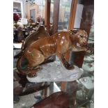 Beswick large mountain lion on rock..