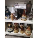 2 shelfs of decanters together with 1st day covers.