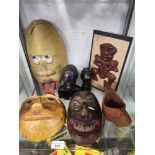 Shelf of african unusual mask wall plaques etc.