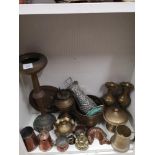Shelf of brass wares.