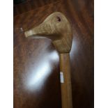 Duck headed carved walking stick with glass eyes.