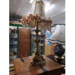 Large ornate table lamp with beaded shade.
