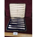 Set of 6 silver Hall marked handled knifes in fitted case.