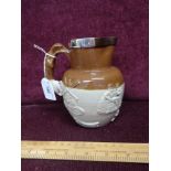 Early royal doulton lambeth stone ware jug with white metal rim.