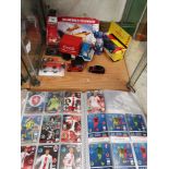 Shelf of collectable toys to include foot ball card album etc.
