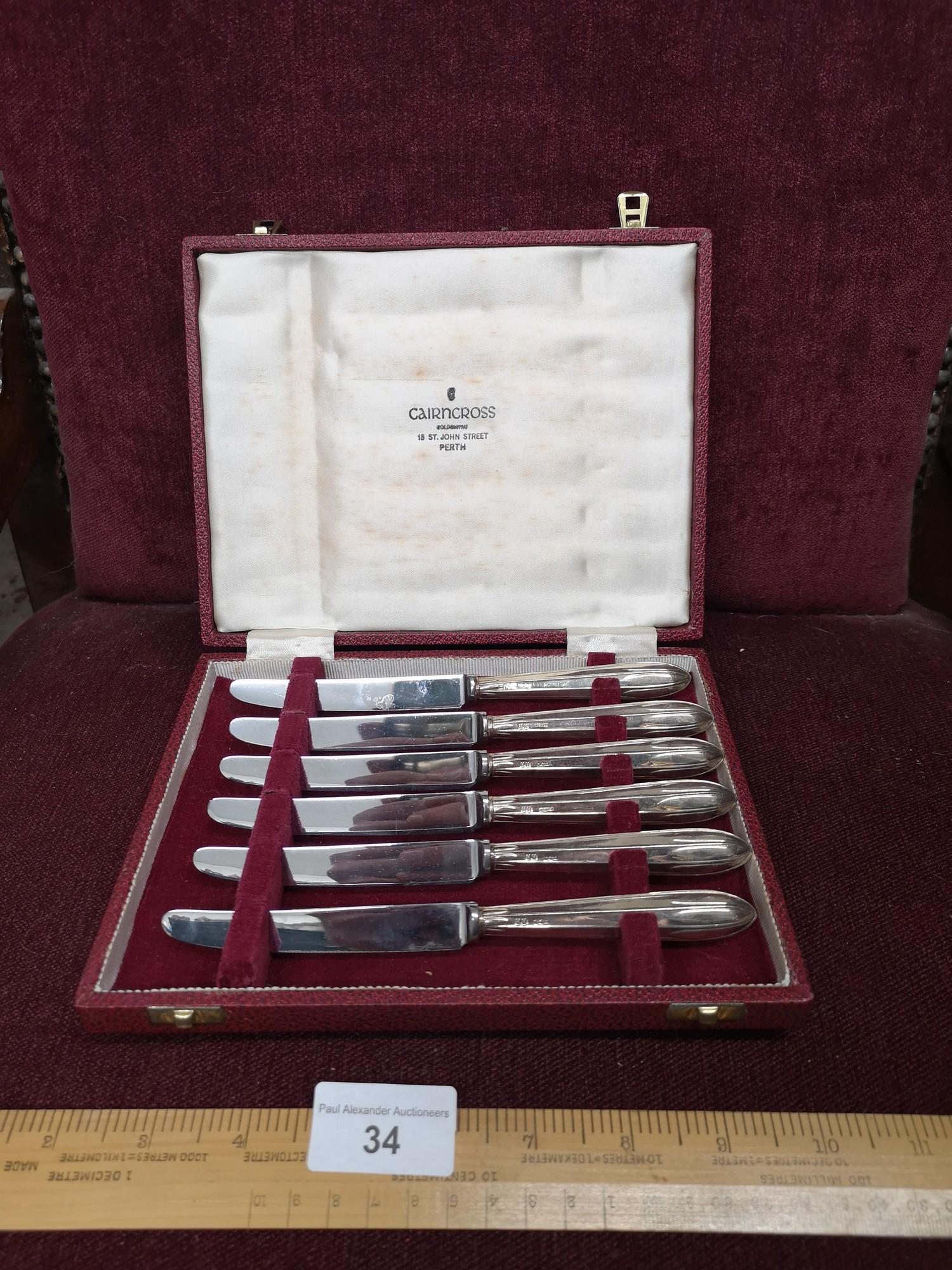 Set of 6 silver Hall marked handled knifes in fitted case.