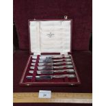 Set of 6 silver Hall marked handled knifes in fitted case.