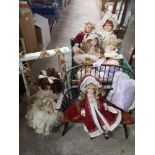 Large lot of porcelain dolls to include bench seat etc.