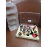 Box of costume rings with display stand.
