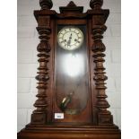 Large victorian wall clock with pendulum.