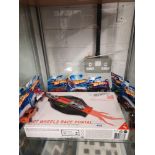 Shelf of hit wheels boxed race portal together with hot wheels boxed cars.