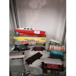 Shelf of train s together with a boxed cabin cruiser clockwork welsotoys boat.