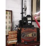 Vintage huntsman projector with a collection of boxed films.