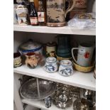 Shelf of collectables includes quimper ware.