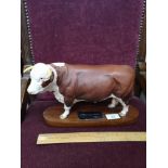 Large Beswick connoisseur Hereford bull on plinth.