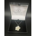 Silver chain set with belleek porcelain flower pendant.