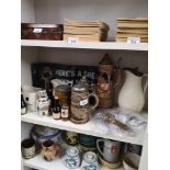 Shelf of collectables includes German steins etc.