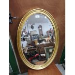 Large oval gilt frame mirror.