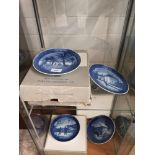 2 shelf of Royal Copenhagen Christmas plates.