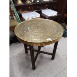 Arabic brass topped table with wooden stand.