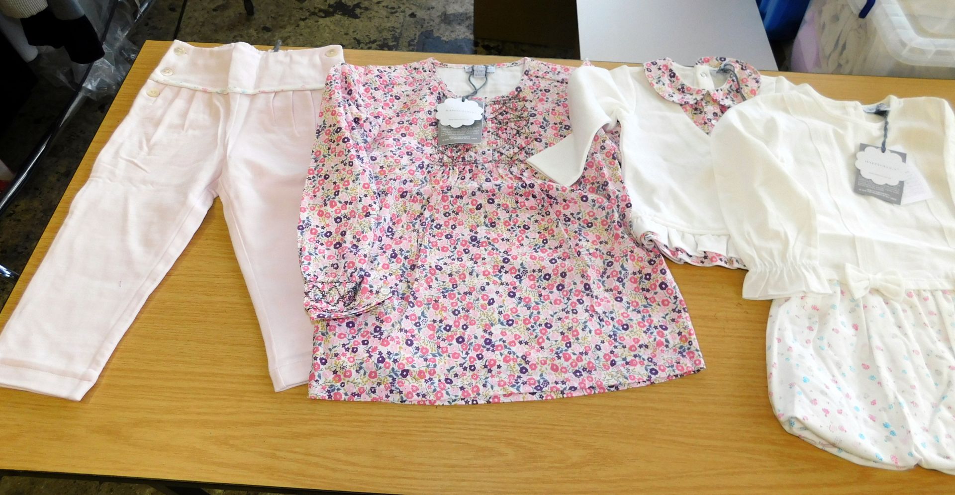 200 Pieces of Happyology Children’s Clothing To Include:- 28 pink trousers, 4 pink floral tops, 8