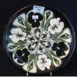 Modern Moorcroft art pottery tube lined cabinet plate or charger, overall on a black ground