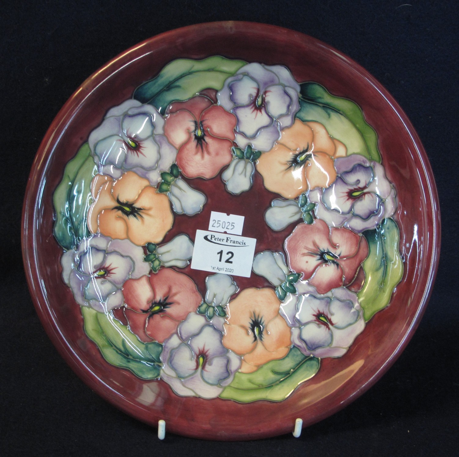 Modern Moorcroft art pottery tube lined cabinet plate or charger, overall on a red ground with