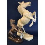 Two modern carved wooden sculptures of rearing horses. (B.P. 24% incl. VAT)