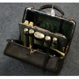 Late Victorian leather overnight bag containing fitted glass jars with engraved silver tops, brushes