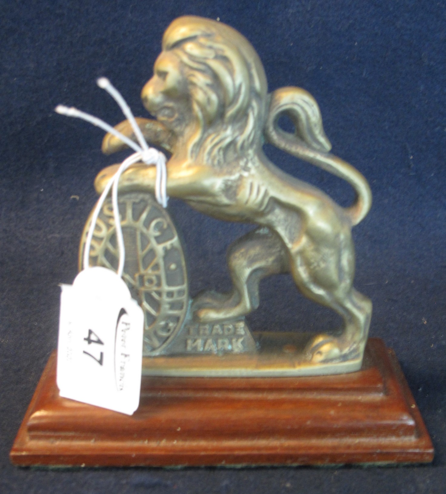 A Justice and Strength brass lion passant mascot, probably from a set of scales originally, now on