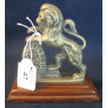 A Justice and Strength brass lion passant mascot, probably from a set of scales originally, now on