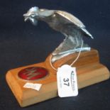 Plated metal 'Bantam' car mascot mounted on a plinth, together with enamel initials plaque 'S.M'. (