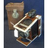 A Shew XIT patent mahogany folding plate camera with Lukos II lens and original leather carrying