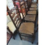 Set of six Lancashire style elm ladder back kitchen chairs with rush seats. (6) (B.P. 24% incl. VAT)
