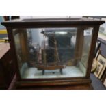 Hand made wooden two masted ship model contained in glazed spring balance case. (B.P. 24% incl. VAT)