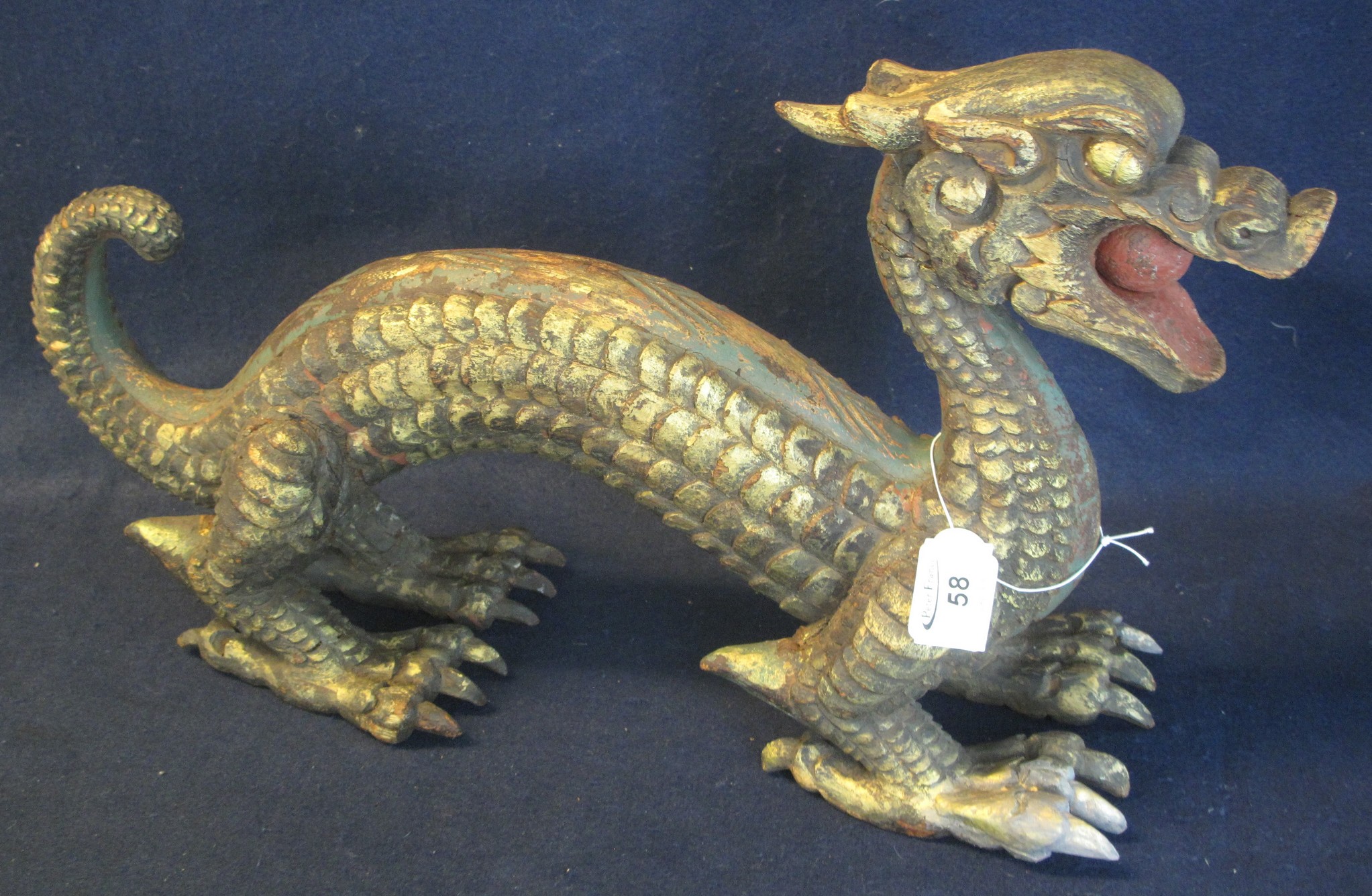 Large carved and gilded wooden dragon, his mouth holding a pearl. (B.P. 24% incl. VAT)