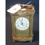 20th Century French brass carriage clock with circular enamel dial, having Roman numerals. the