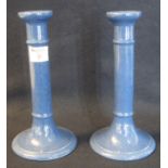 A pair of Moorcroft Burslem powder blue candlesticks. Impressed marks to the under side, height 25cm