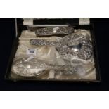 Cased silver backed repousse decorated dressing table brush, comb and mirror set, with Birmingham